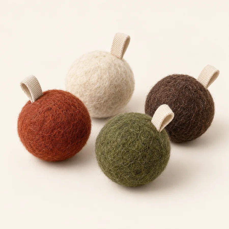 Set of four wool felt cat prey ball concepts in warm colors